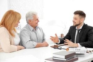 A woman sits with a counselor in a comfortable office, sharing in a supportive conversation.